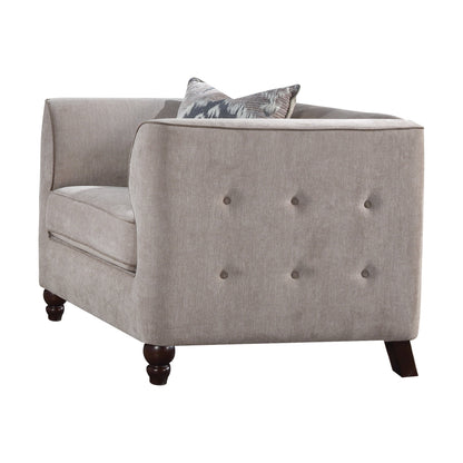 Tan velvet tufted accent chair shown with espresso wooden legs and one decorative pillows.