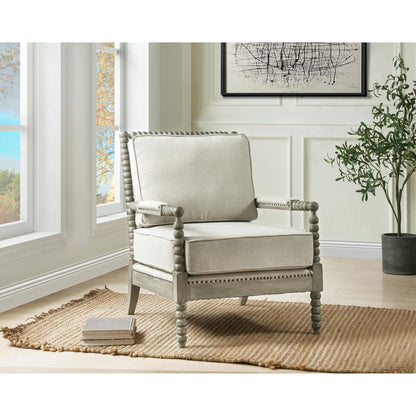 Jordan accent chair shown in decorated living room. Jordan Accent Chair has beige linen upholstry cushions with a gray oak finish frame. The frame has an intricate bubble detailing along the arms, legs and back of the accent chair. 