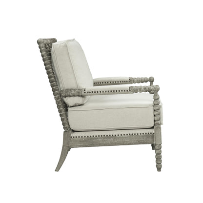 Jordan Accent Chair has beige linen upholstry cushions with a gray oak finish frame. The frame has an intricate bubble detailing along the arms, legs and back of the accent chair. 