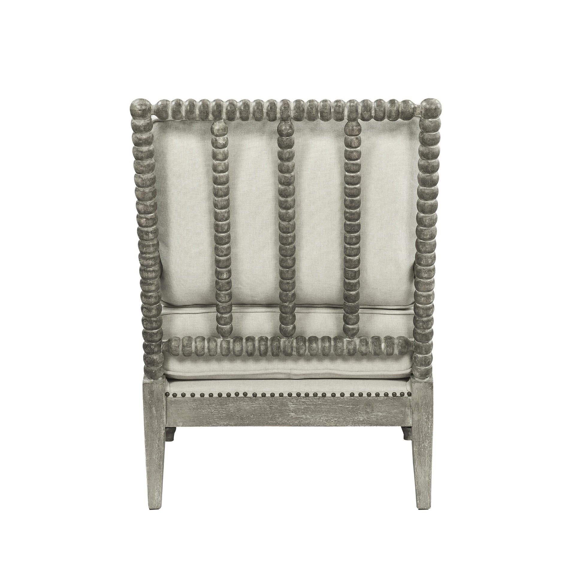 Jordan Accent Chair has beige linen upholstry cushions with a gray oak finish frame. The frame has an intricate bubble detailing along the arms, legs and back of the accent chair. 