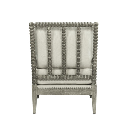 Jordan Accent Chair has beige linen upholstry cushions with a gray oak finish frame. The frame has an intricate bubble detailing along the arms, legs and back of the accent chair. 