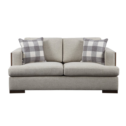 Light gray loveseat, exposed  wooden trim with a rich walnut finish, and track style arms. Two decorative pillows shown resting on the loveseat