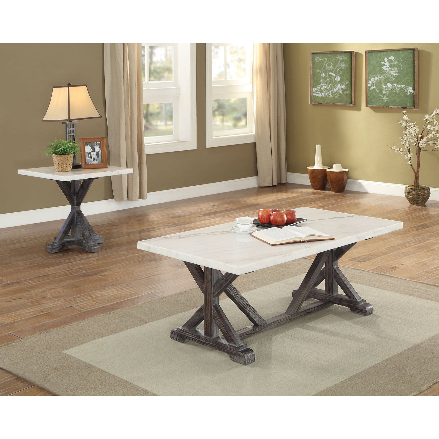 Romina Coffee Table pictured in decorated living room. The coffee table has a white marble top with warm toned veins. The frame is a weathered espresso wood finish. The Legs form "x" on each side with two diagnal wood peices towards the bottom center.